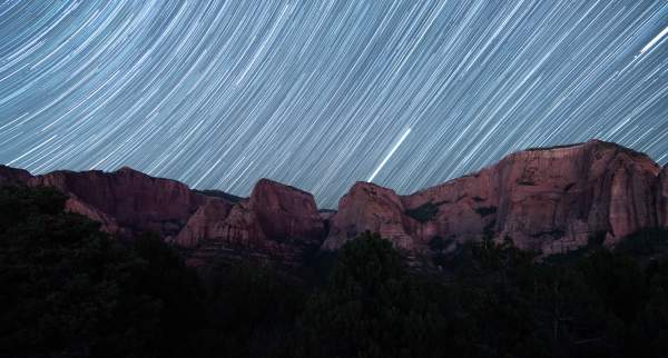 Dark sky views in Kolob Canyons above the vibrant red rock cliffs.