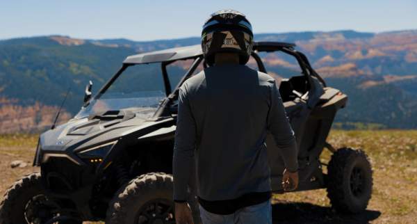 An off highway vehicle tour guide walks toward a vehicle at the High Mountain Overlook in Brian Head, Utah.