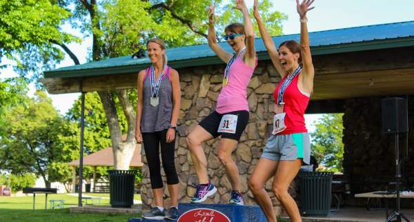 Three women celebrate their medals at the Utah Summer Games in Cedar City, Utah.
