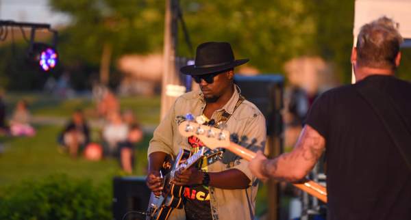 Musician playing guitar on outdoor stage
