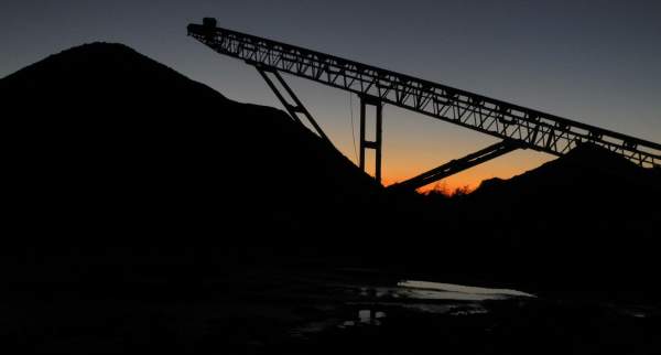 Mining equipment silhouetted against sky