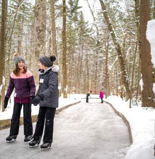 people iceskating on trail in woods