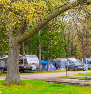 Campground with trailers, tents, and vehicles