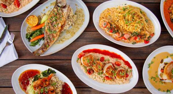 An overhead view of several different seafood dishes prepared by Oceanic in Pompano Beach