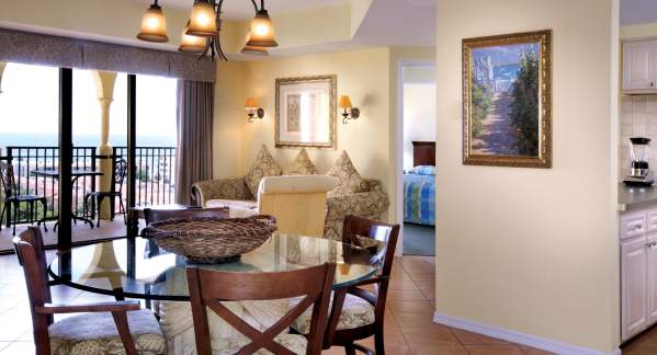 The interior living room and dining room of a condo unit at Wyndham Sea Gardens in Pompano Beach, FL