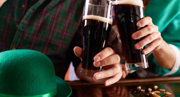 Two hands toasting with glasses of Guinness beer!