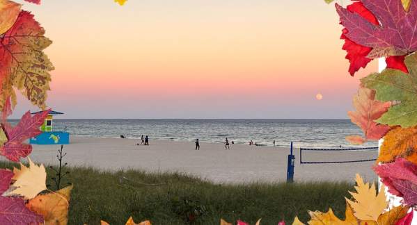 Full Moon Rising on the Beach with a colorful fall leaf frame around it.