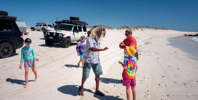 Tour guide Brian Lee on a beach north of Djarindjin on the Dampier Peninsula showing his tour group a beach find