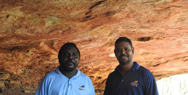 Wijingarra Tours cave guides Gideon Mowaljarlai and Neil Maru standing at a rock art site on the Kimberley Coast.