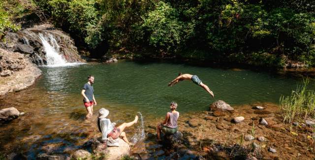 Man jumping into Chorro la Tortuga in Cocle province, sharing with friends