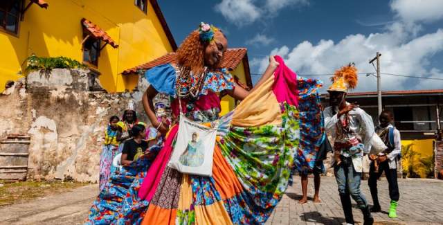 Woman dancing with a colorful Pollera Conga at colonial street of Portobelo, Colon province