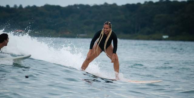 Happy surfer Surfer takes a wave at Black Rock Surf, Bocas del Toro province