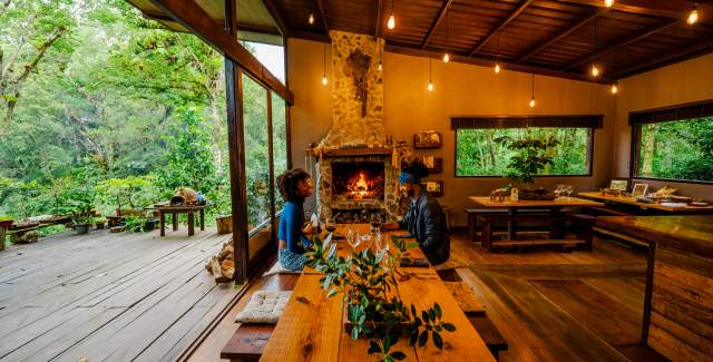 Couple enjoying near fireplace in Hacienda Mamecillo in Boquete, Chiriqui Province, Panamá
