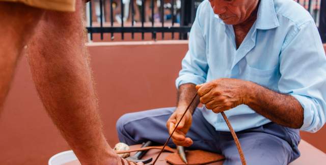A man craft a traditional leather sandal named cutarra