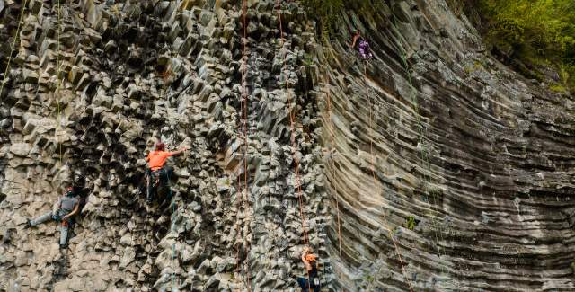 Huge rock wall with climbers on it