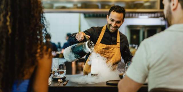 Chef serving a dish prepared with liquid nitrogen at a fine dining restaurant in Panama City.