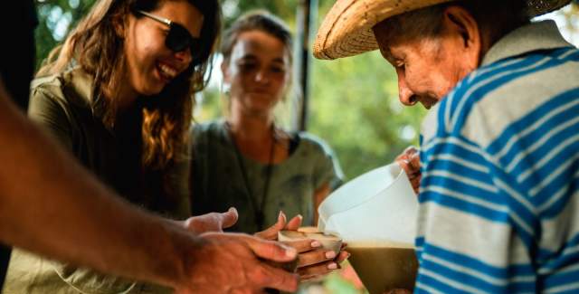 A man serving juice to a group in El Valle de Anton.