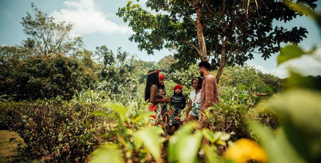 Tourists interacting with members of the Emberá-Wounaan community in the rainforest of Darien Province, Panama.