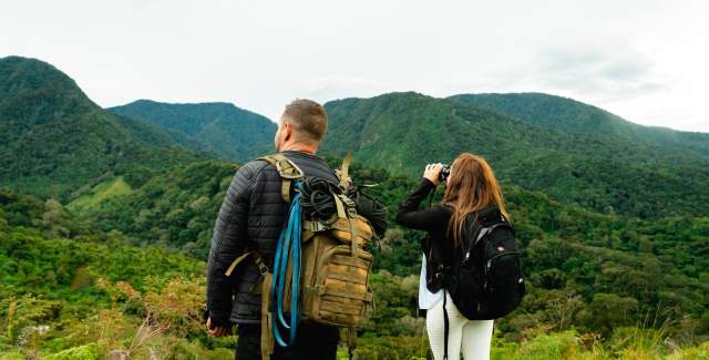 A couple admiring the green hills of Mount Totumas at La Amistad International Park