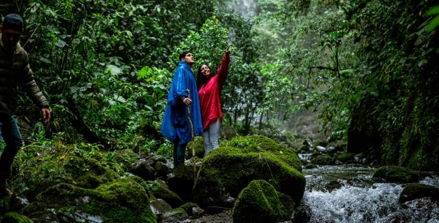 Visitors walk near the river in FInca Guardia