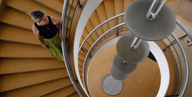 Person walking down a spiral staircase at De La Warr Pavilion