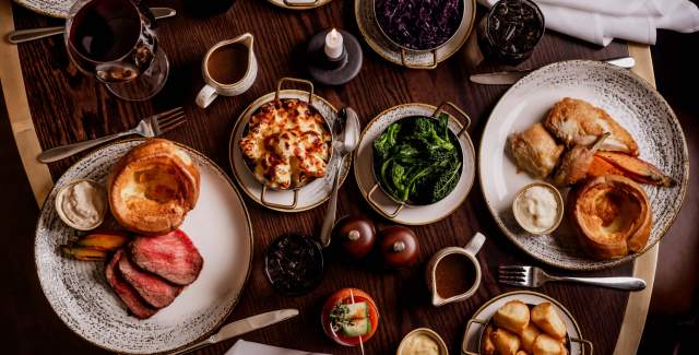 A table filled with roast dinner and trimmings at the Pearly Cow
