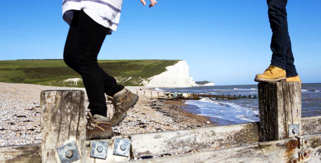 A couple of walkers on the beach at Birling Gap near Seven sisters in the South Downs National Park