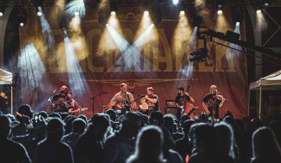 Zach Bryan and his band play on the Peacemaker Festival main stage.