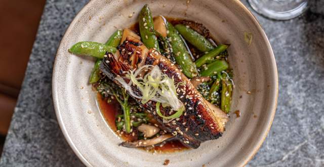 Plate of Fish with sugar snap peas and sauce at Franklin Ave Cocktails & Kitchen