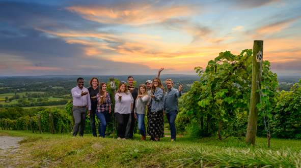 Diverse Group Photo at Winery with Sunset