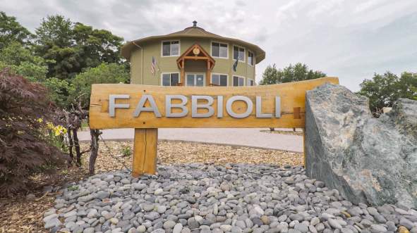 Wooden Fabbioli Cellars entrance sign in front of the round tasting room in Leesburg, Virginia