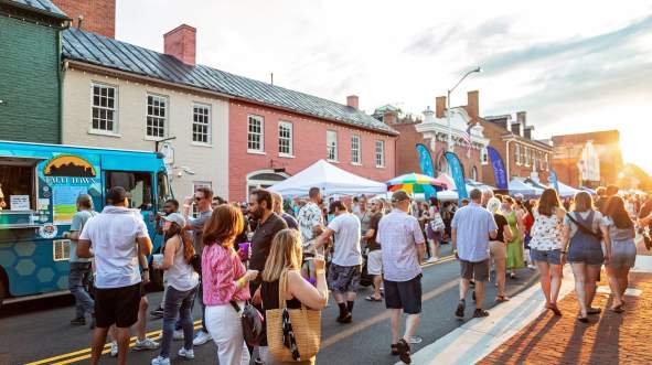 Crowd of people on King Street enjoying Taste Leesburg a culinary festival in Downtown Leesburg Virginia