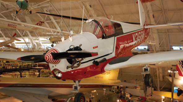 Red and white vintage aircraft with striped propellers displayed at the National Air and Space Museum in Loudoun