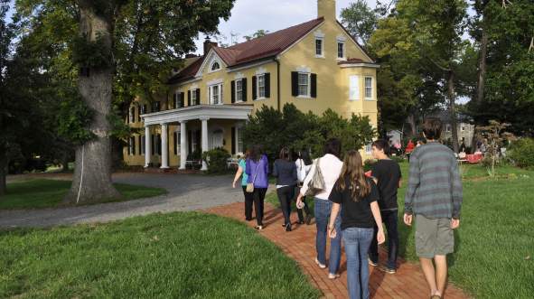 Group of tourist walking towards George C Marshall's home The Dodona Manor, a historic site in Leesburg, Virginia.