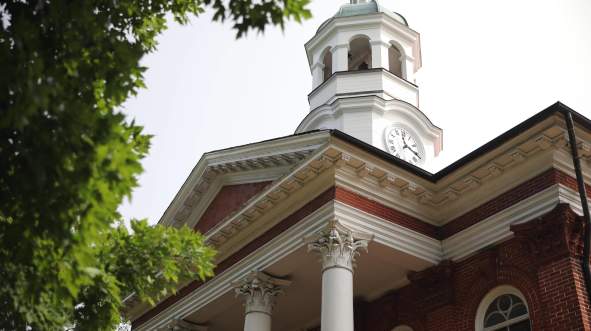 Red Brick Loudoun County Courthouse with white Corinthian columns and clock tower in downtown Leesburg, Virginia