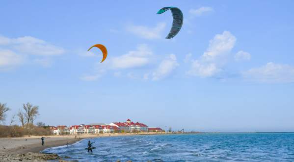 People flying kites on the beach