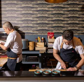 Chefs at Craft Omakase focused on plating dishes.