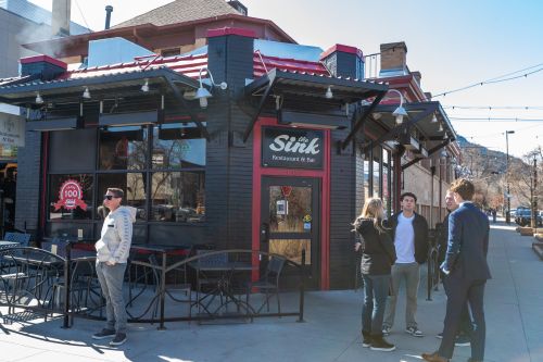 People stand in front of The Sink restaurant located on The Hill in Boulder