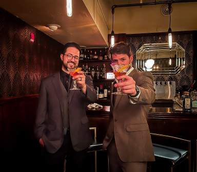 Two people getting drinks at the downstairs speakeasy at Kress Cinema & Lounge