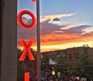 Moxi Theater neon sign overlooking downtown greeley