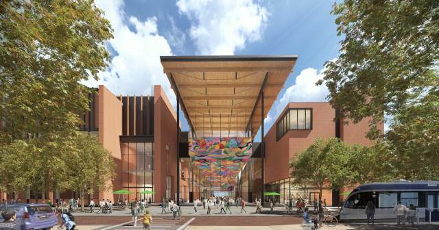Austin Convention Center rendering showing the new building's West Entrance from street level with pedestrians, cyclists and a light rail along the street. The multi-story building includes a mural along the ceiling of the entrance