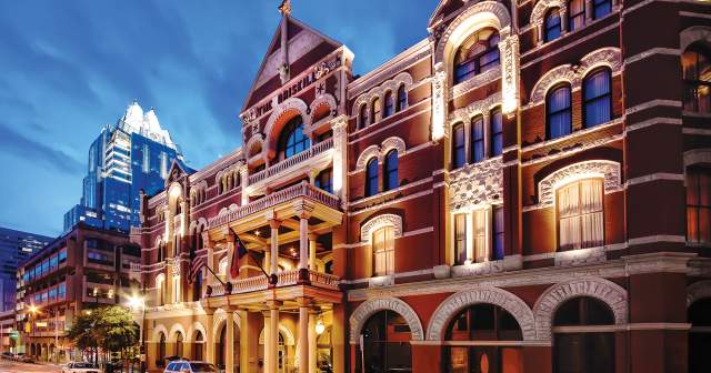 The Driskill Hotel exterior at sunset with frost bank tower behind