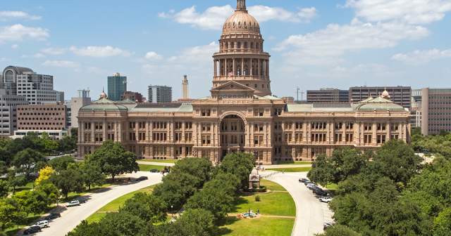 Image of the Texas State Capitol building South Facade and tree-lined walkways leading to building