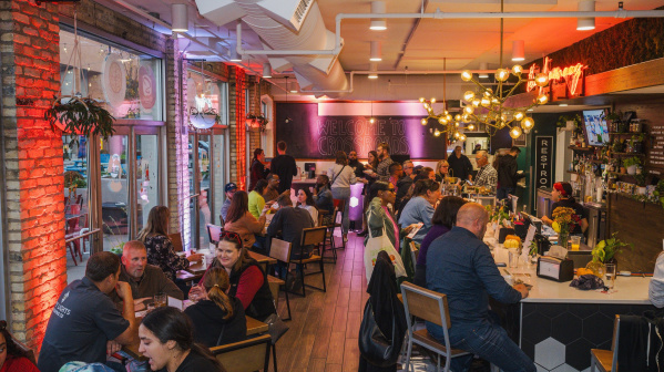 Interior shot of a packed dining hall at Crossroads Collective