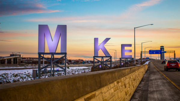 big MKE letters by airport, sunrise