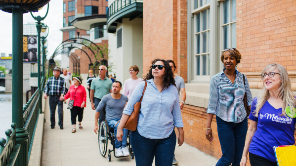 tour group walks down riverwalk