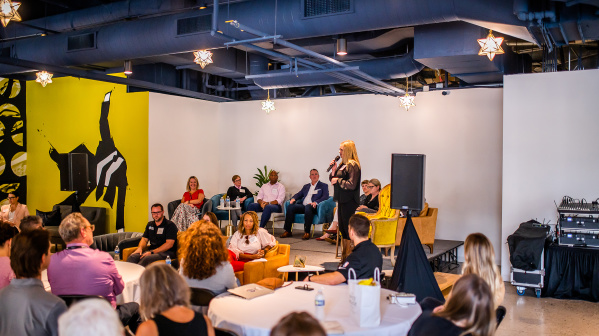 speaker talking to a room of people in the starlight room at third street market hall