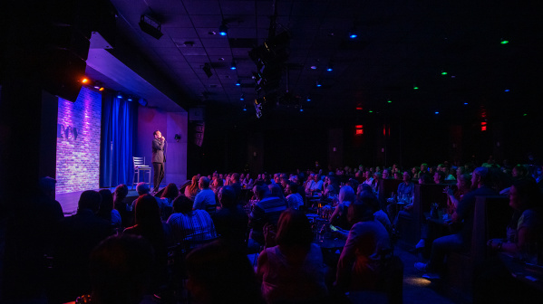 Improv performer on stage with audience