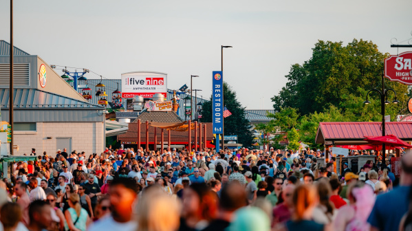A large crowd fills the main walkway near the Five Nine Amphitheater, Central Mall and food stands during a busy afternoon at the Wisconsin State Fair.