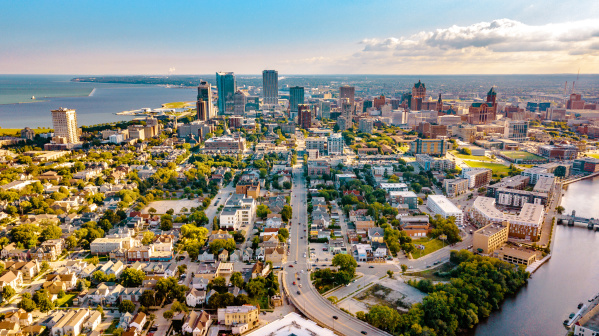 view of the Milwaukee skyline from a drone over Lake Michigan and the Milwaukee River